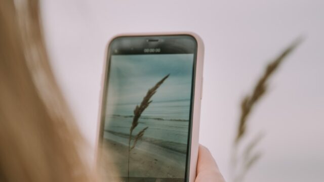 a woman holding a cell phone in her hand